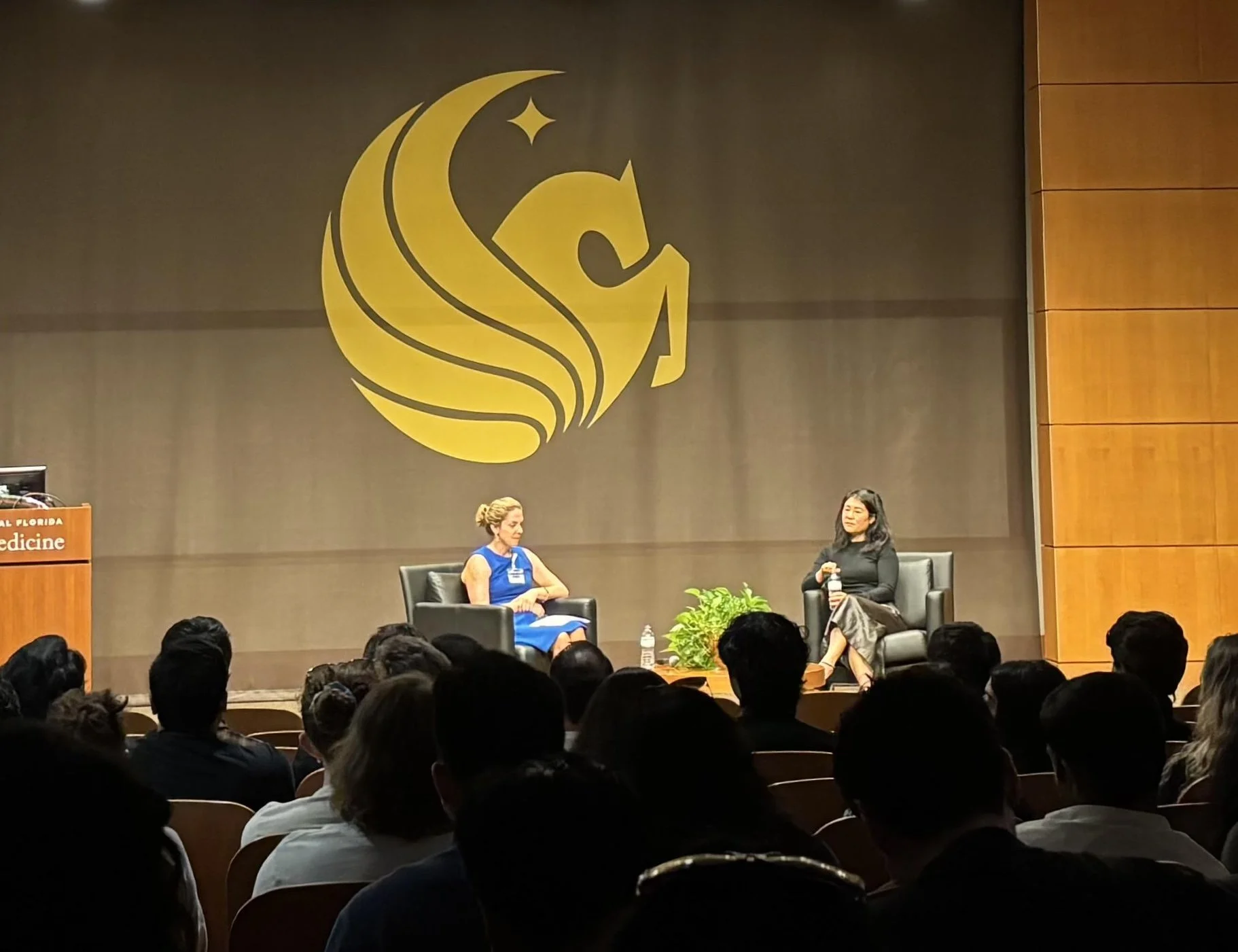 Dr. Suzan Song speaking on stage